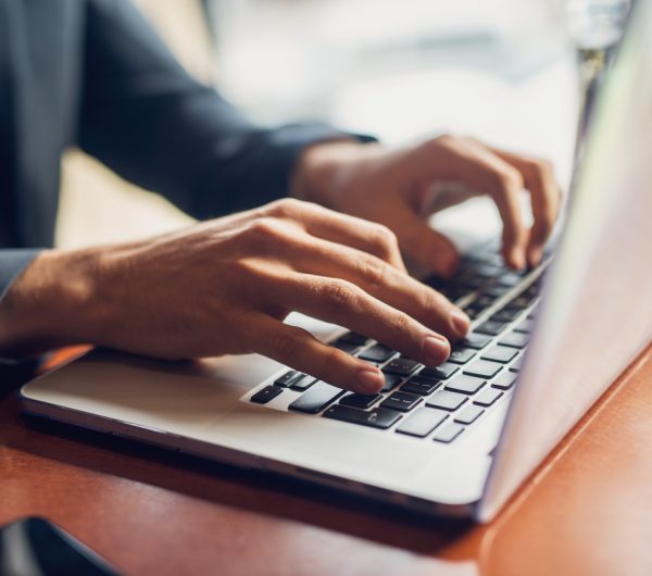 Close up of a hands of a businessman on a keyboard.